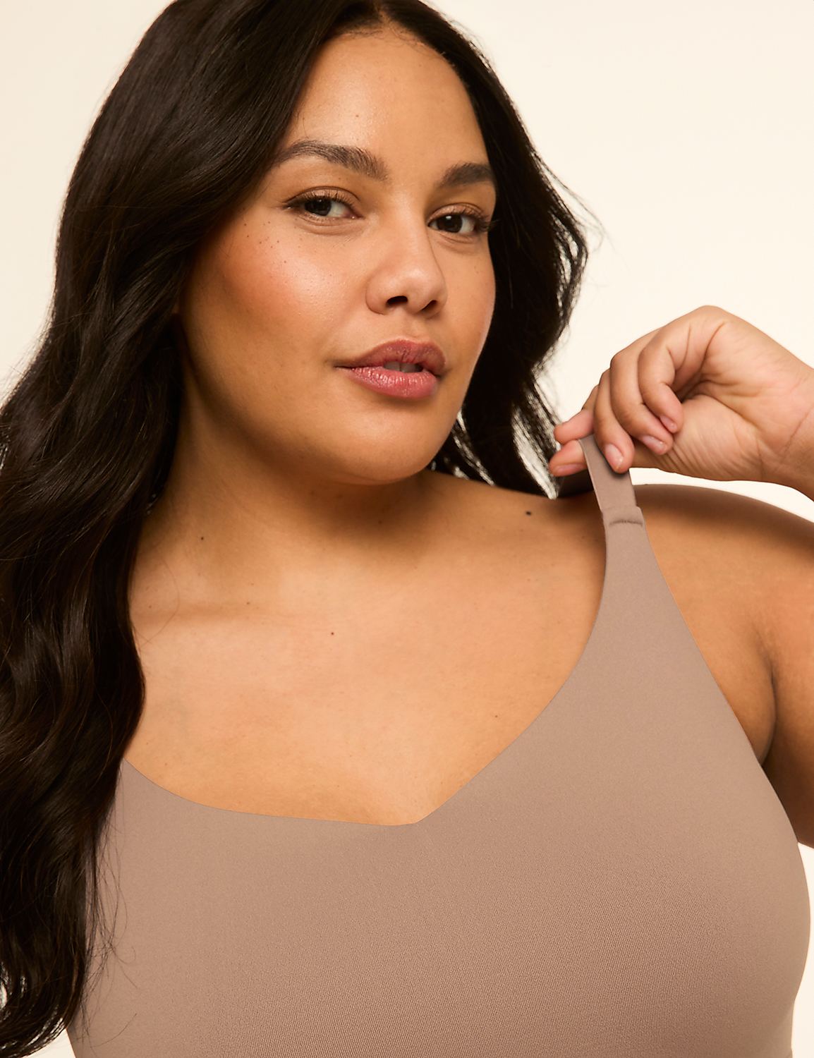 A woman with dark hair and a tan top is shown against a plain, light background. Product Image 4