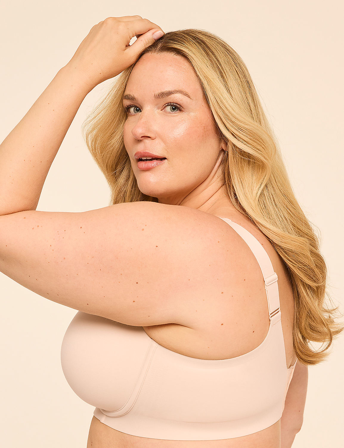 A woman with blonde hair and fair skin, wearing a nude bra, poses against a plain, light-colored background. Product Image 3