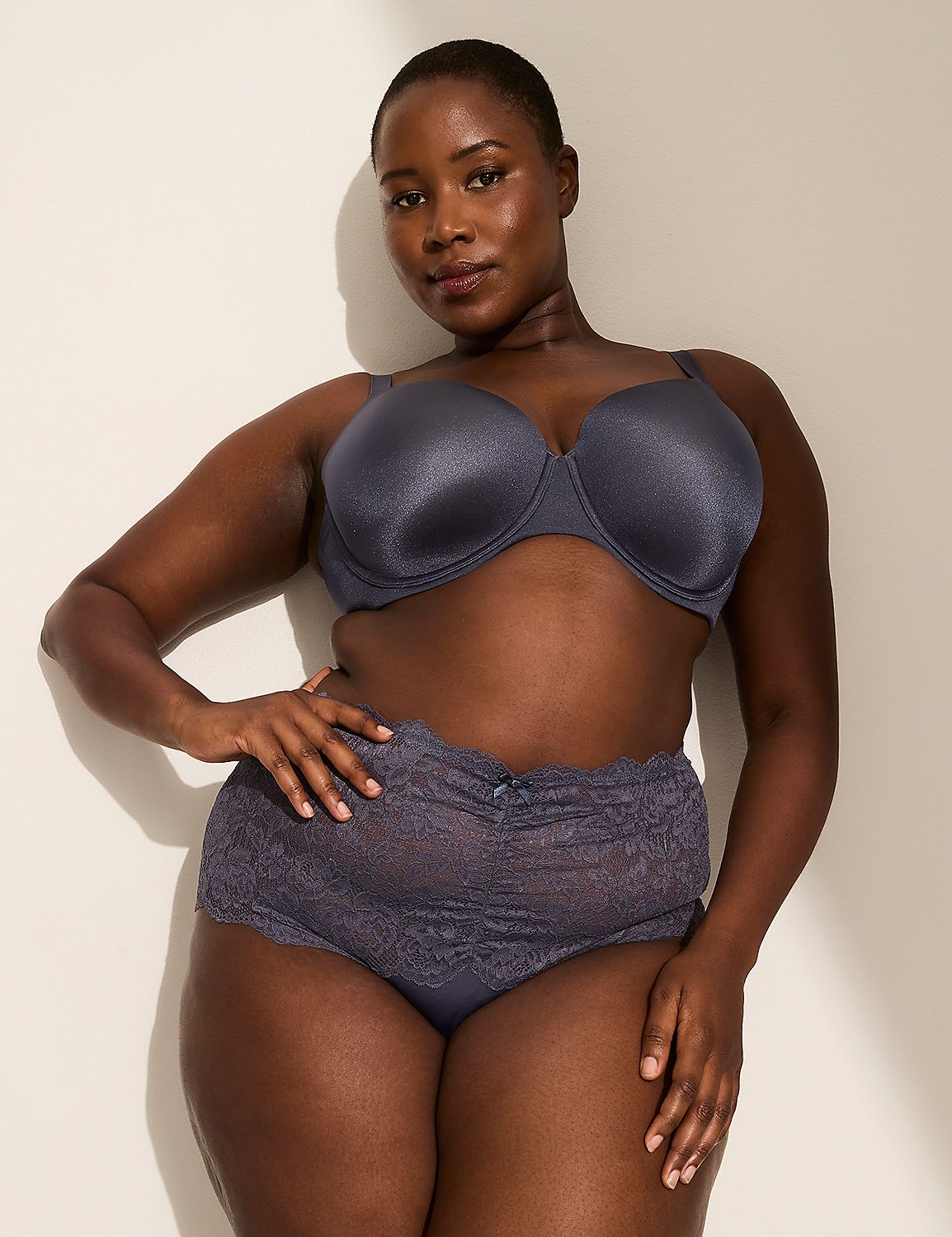 A woman in a gray bra and lace-trimmed underwear stands against a plain, shadowed wall. Product Image 4