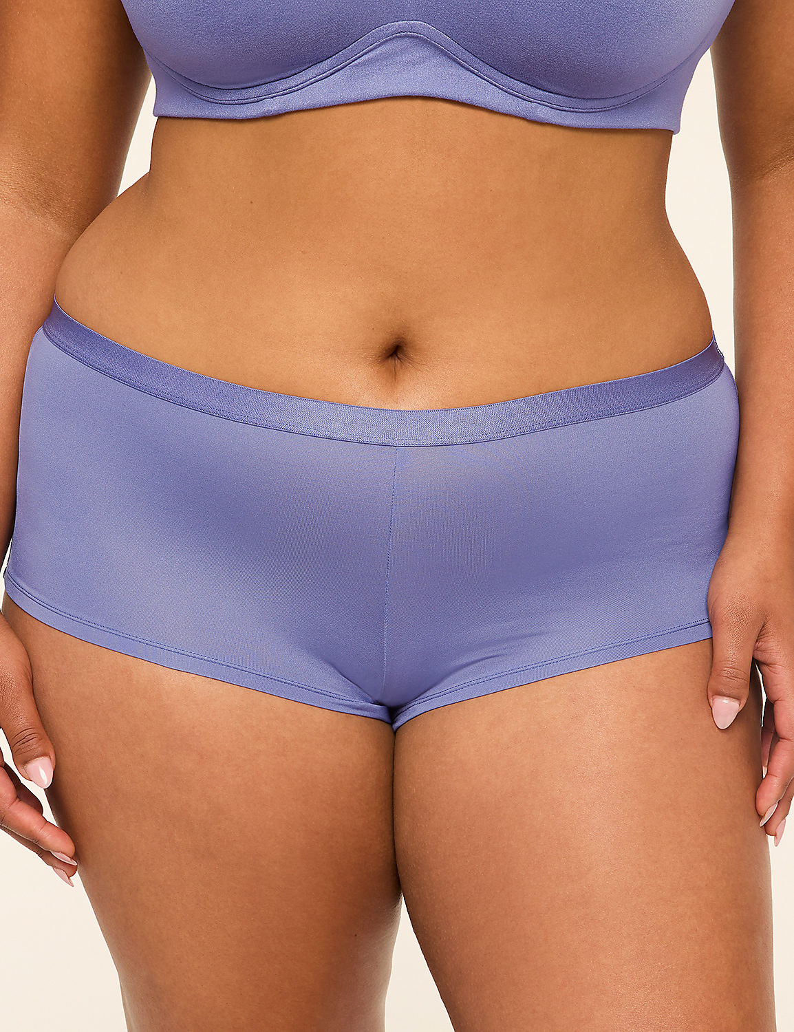 A person's torso is shown from the waist down, wearing purple underwear and a matching bra, against a plain background. Product Image 1