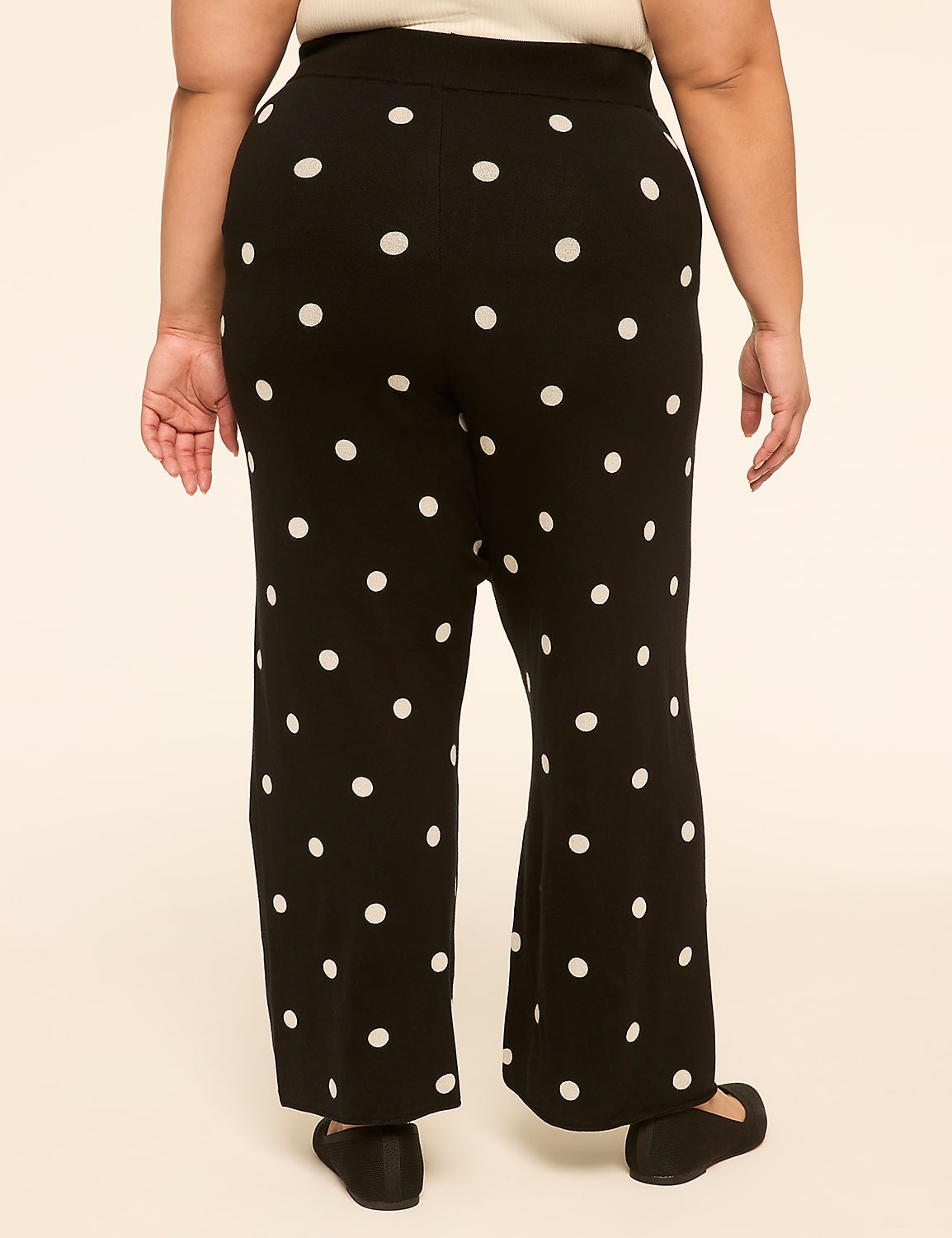 A person wearing black polka dot pants stands against a plain, light-colored background. Product Image 2