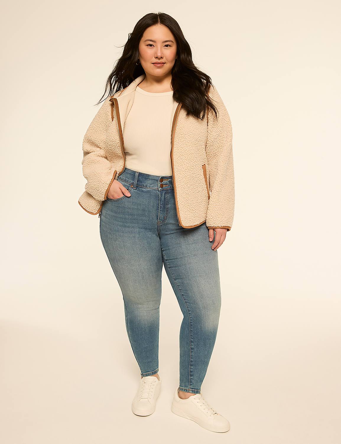 A woman in a cream-colored fleece jacket and blue jeans stands against a plain, light-colored background. Product Image 3