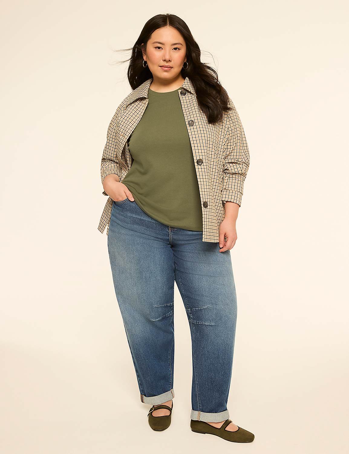 A woman in a green t-shirt, plaid jacket, and jeans stands against a plain, light-colored background. Product Image 3