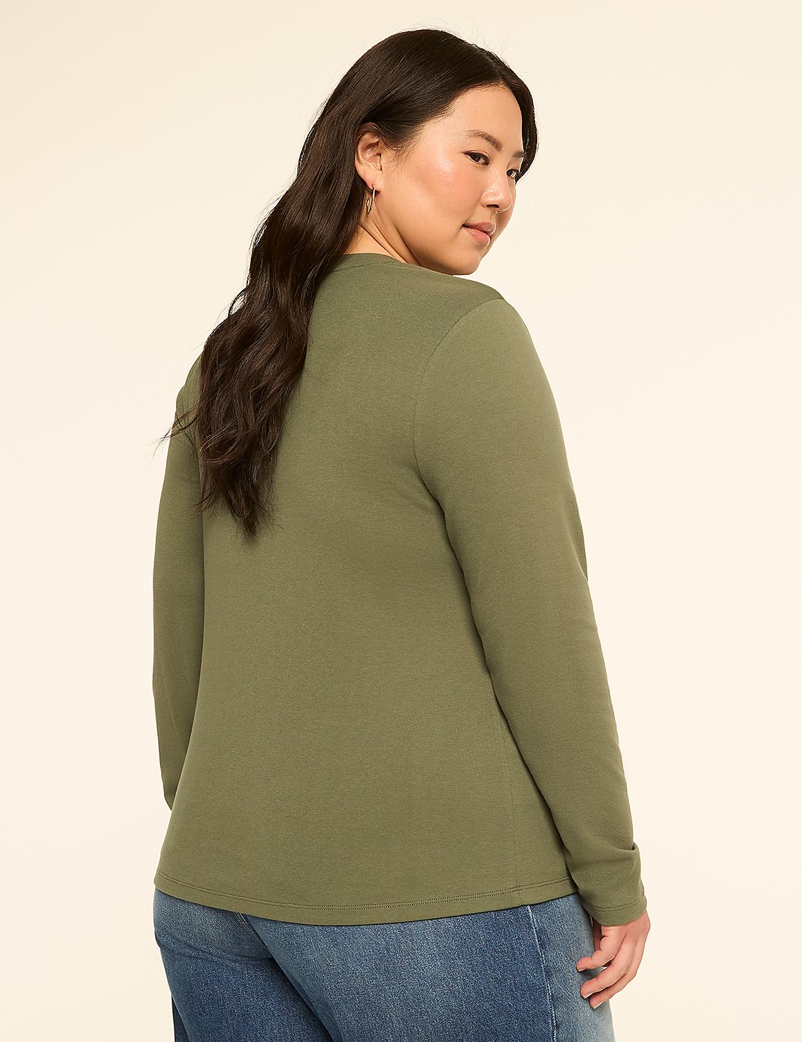 A woman in a green long-sleeved shirt and blue jeans stands against a plain, light-colored background. Product Image 2