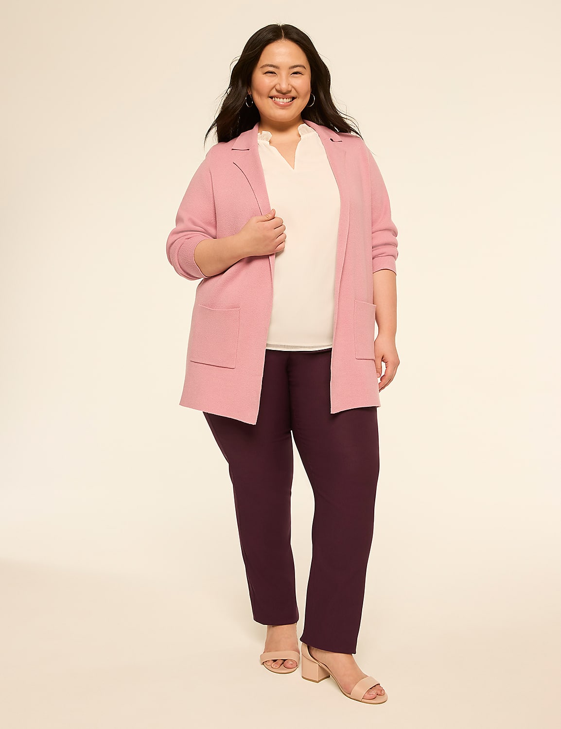 A smiling woman in a pink cardigan and plum pants stands against a plain, light background. Product Image 3