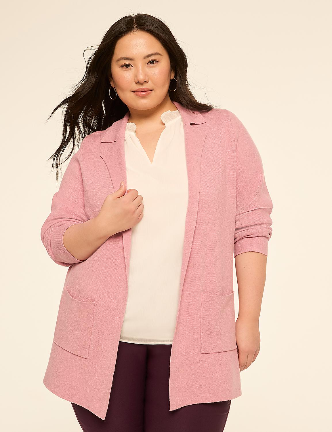 A woman in a pink cardigan and white top stands against a plain, light-colored background. Product Image 1