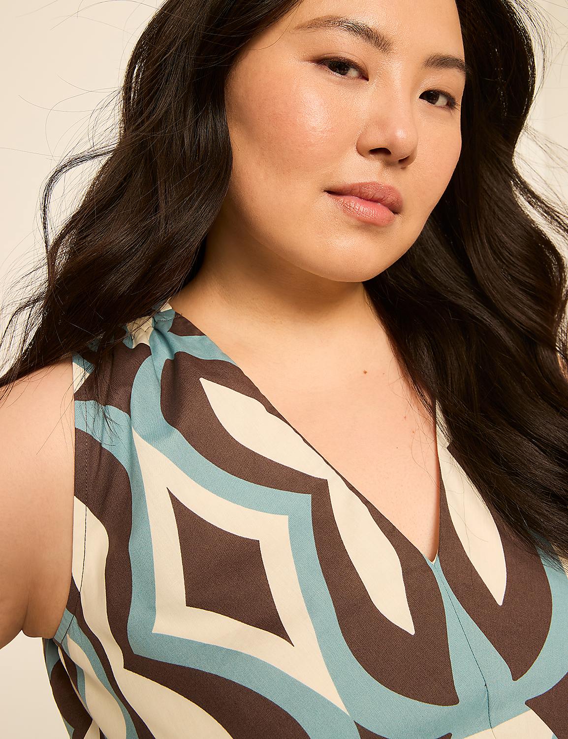 A woman with dark hair and a patterned dress is shown against a plain background. Product Image 3