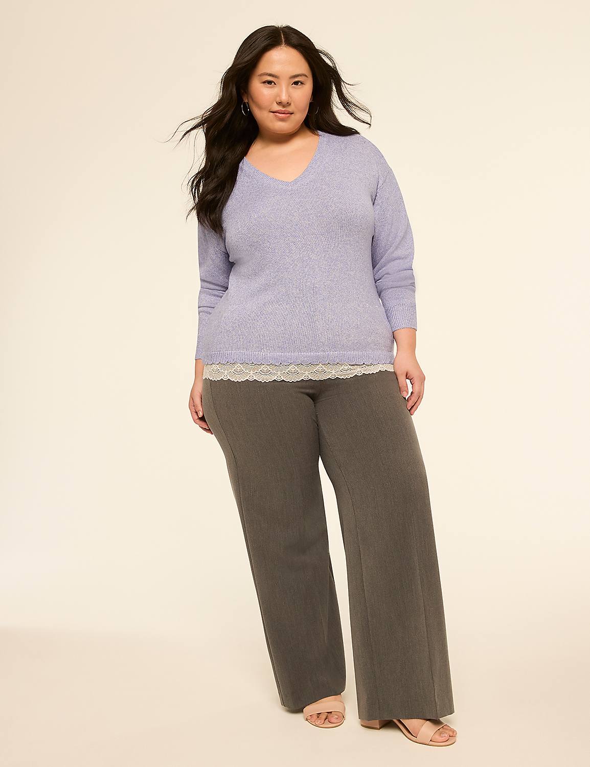 A woman in a lavender v-neck sweater and gray pants stands against a plain, light-colored background. Product Image 3