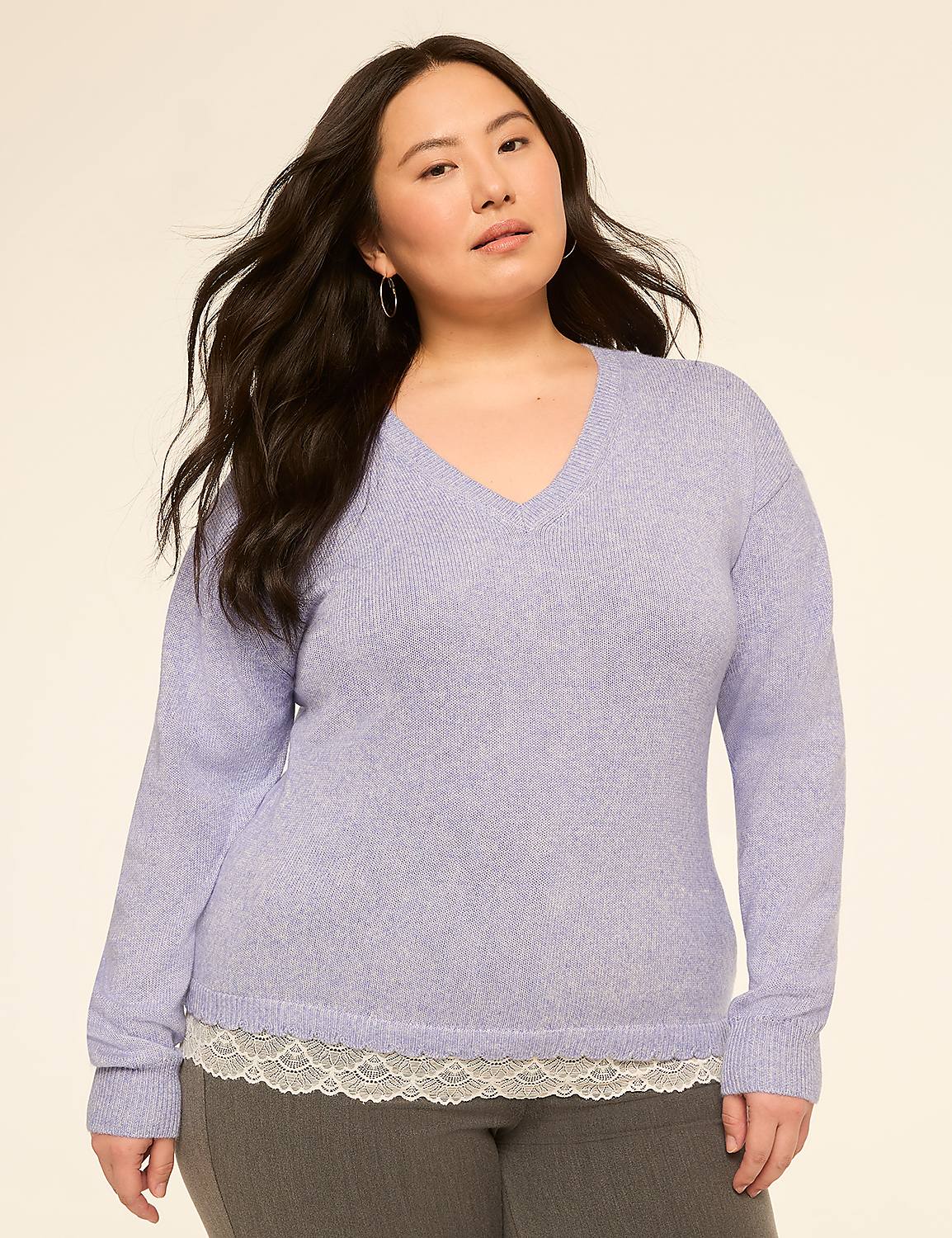 A woman in a light purple v-neck sweater layered over a white lace-trimmed camisole stands against a plain beige background. Product Image 1