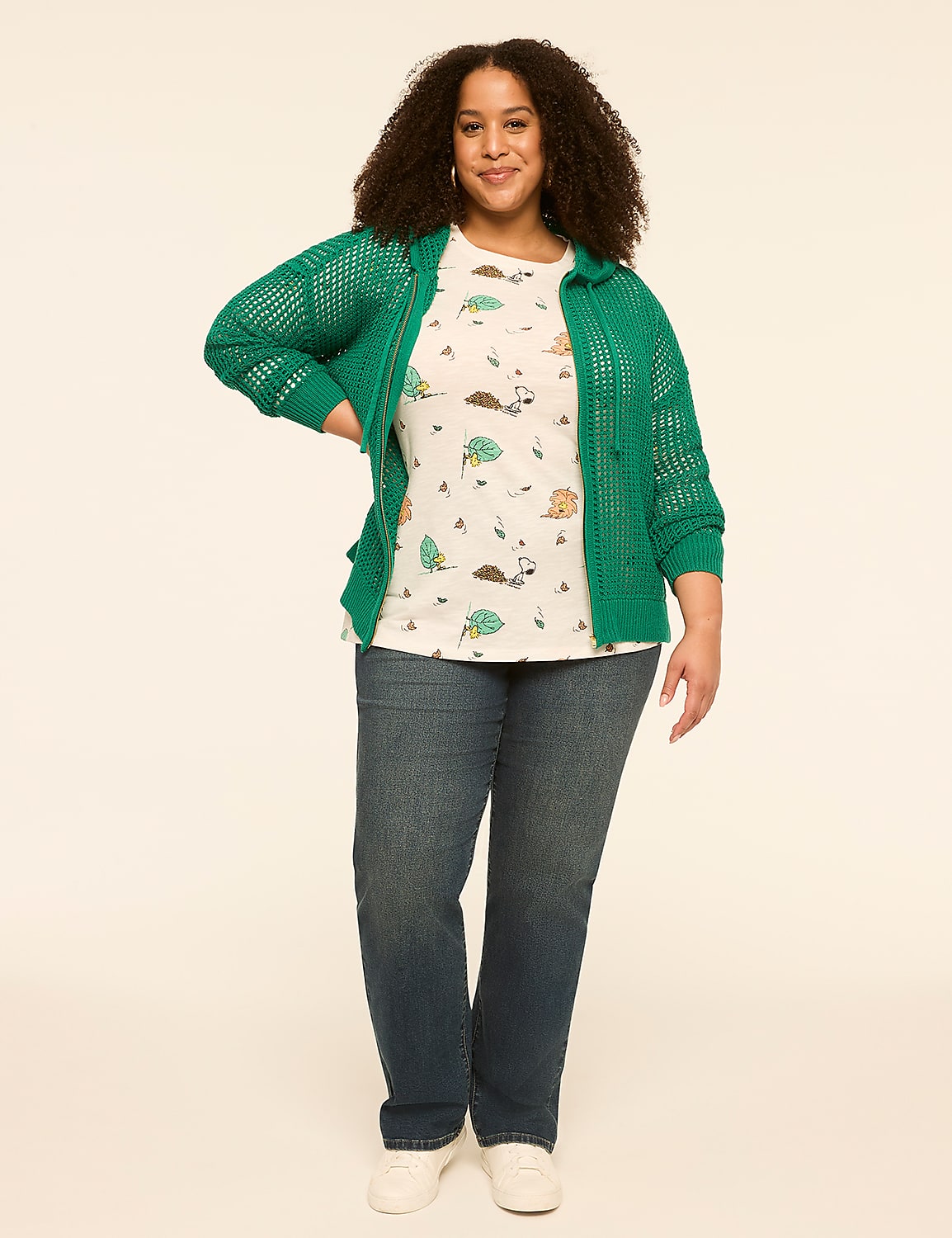 A woman in a green cardigan and patterned t-shirt stands against a plain, light background. Product Image 3