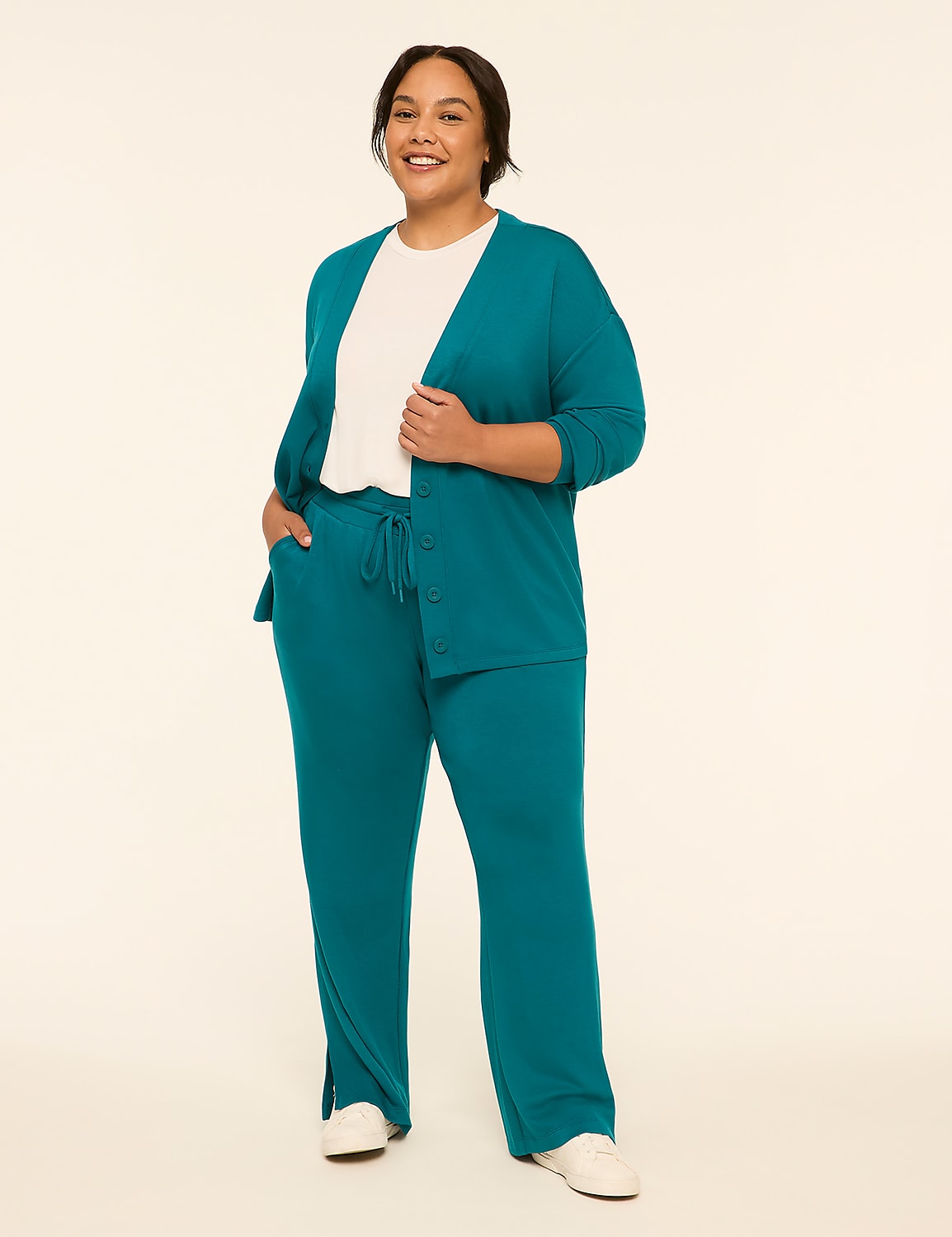 A woman in a teal cardigan and matching pants stands against a plain, light-colored background. Product Image 3