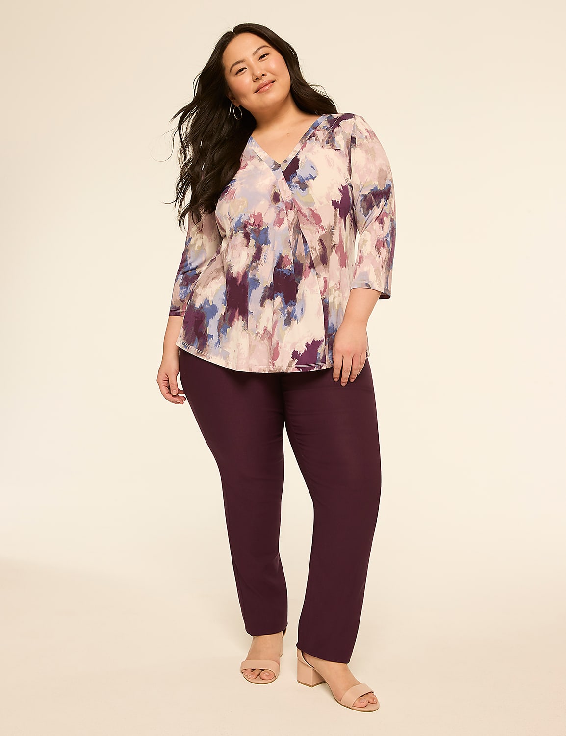 A woman in a colorful abstract print blouse and plum pants stands against a plain, light background. Product Image 3