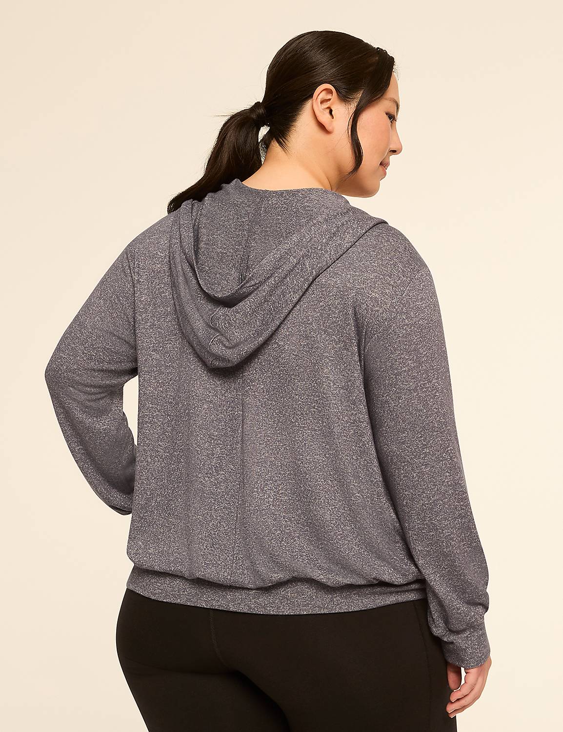 A woman in a grey hoodie and black leggings stands against a plain, light-colored background. Product Image 2