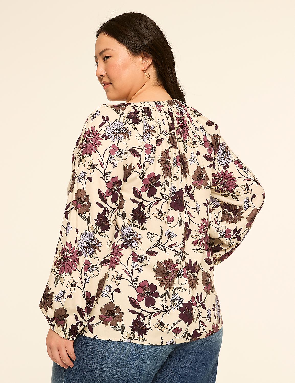 A woman in a floral blouse and jeans stands against a plain, light-colored background. Product Image 2