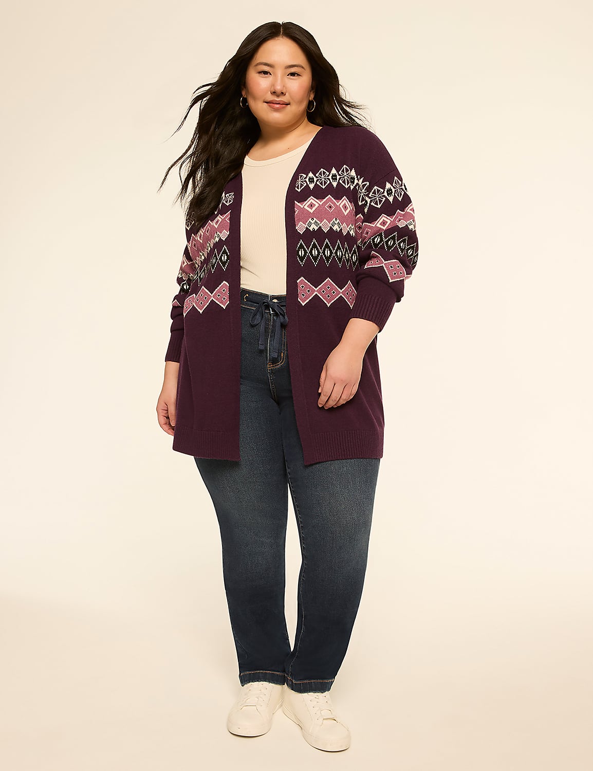 A woman in a patterned cardigan and jeans stands against a plain, light background. Product Image 3