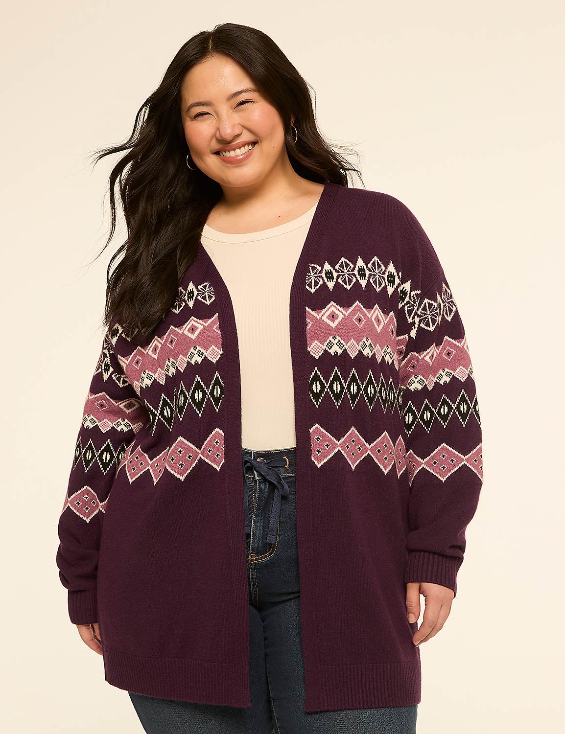 A smiling woman in a patterned cardigan stands against a plain, light-colored background. Product Image 1