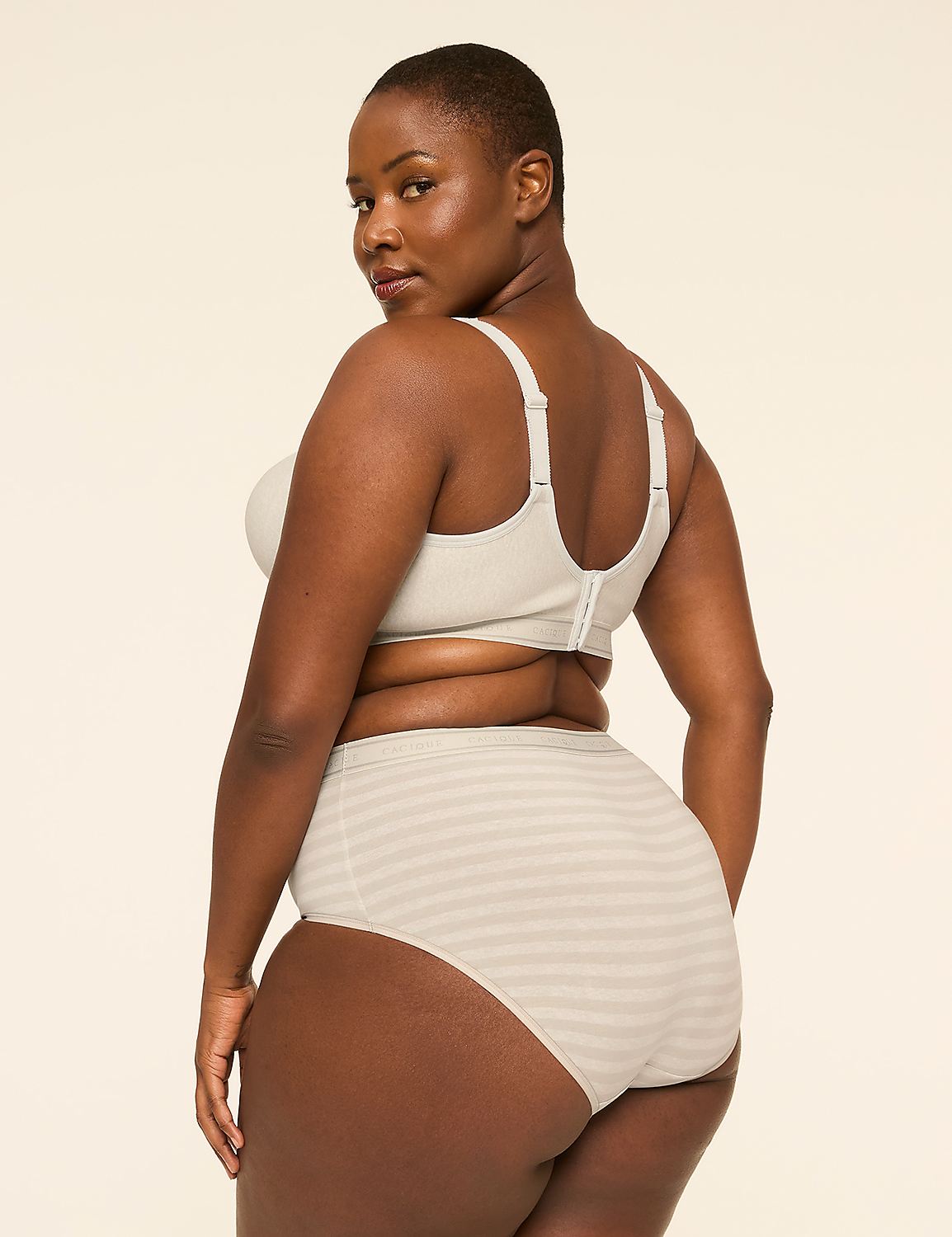 A woman in a beige bra and striped underwear stands against a plain, light background. Product Image 2
