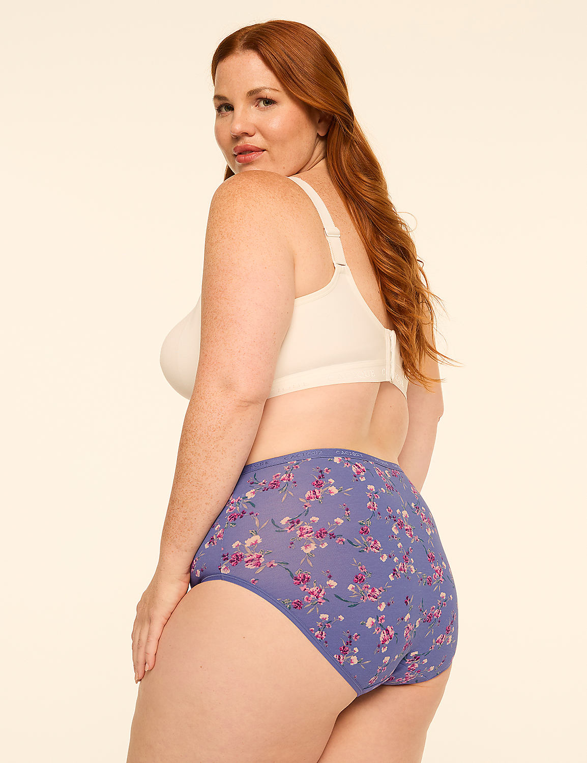 A woman with red hair poses in a cream-colored bra and floral-patterned underwear against a plain, light background. Product Image 2