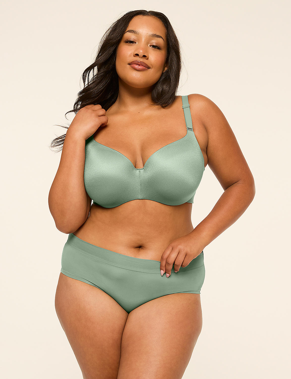 A woman in a sage green bra and underwear stands against a plain, light beige background. Product Image 4