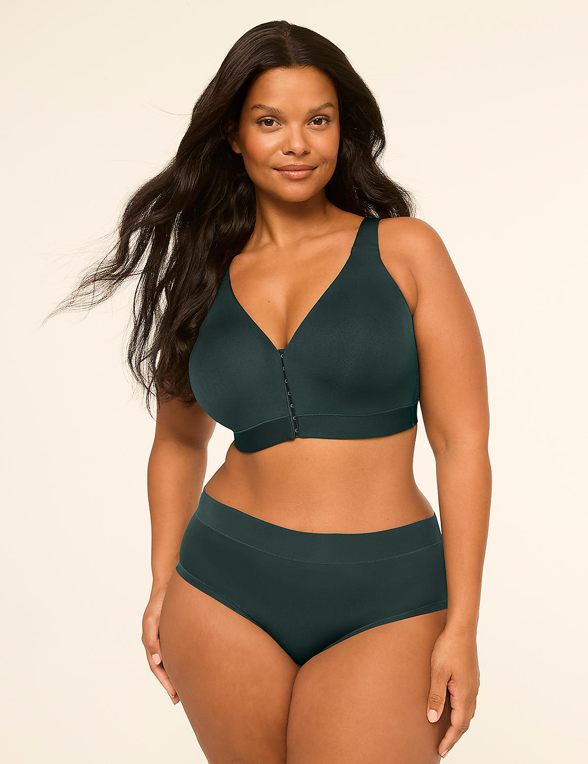 A woman with long, dark hair poses in a dark teal bra and matching underwear against a plain, light background. Product Image 4