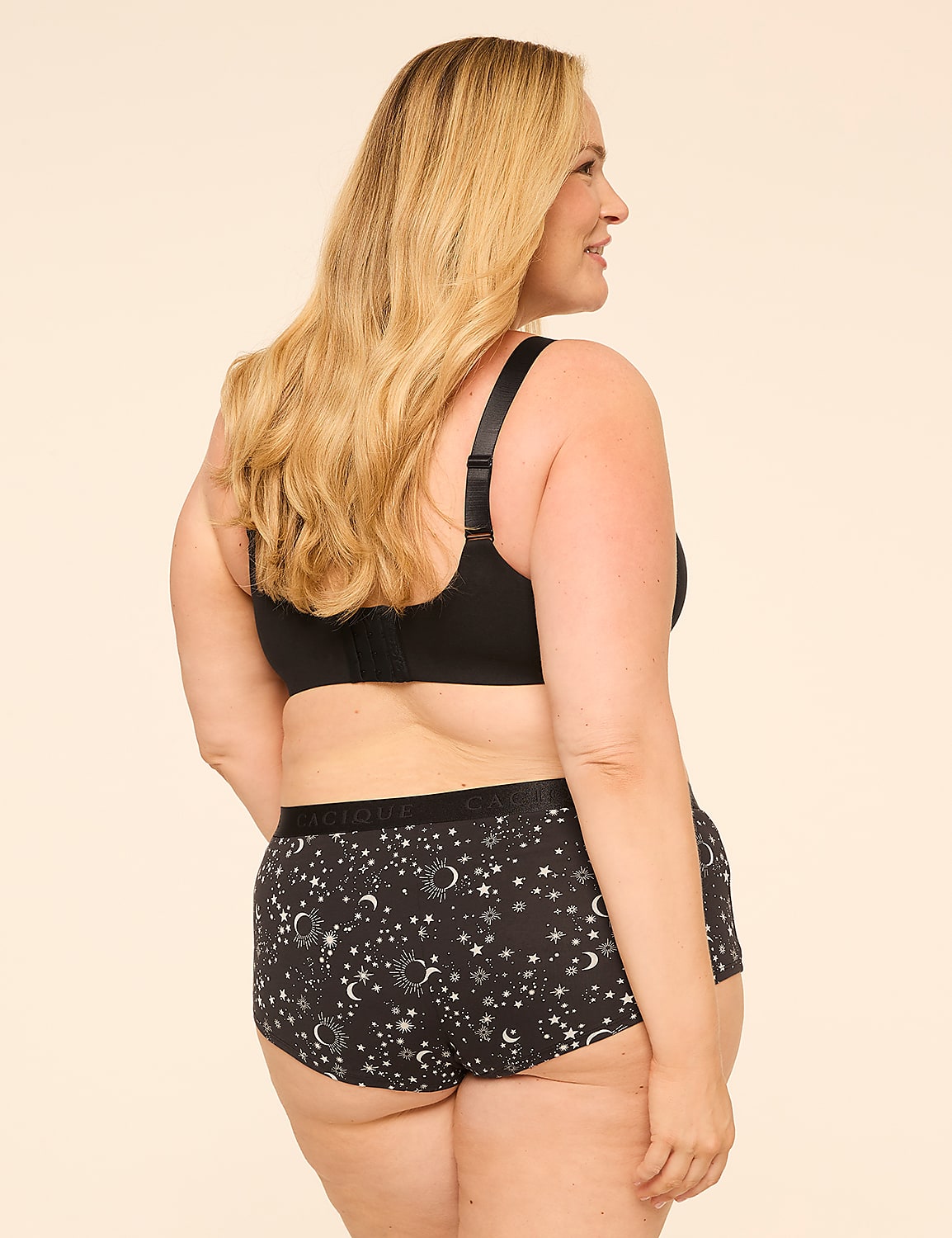 A woman in a black bra and patterned underwear stands against a plain, light-colored background. Product Image 2