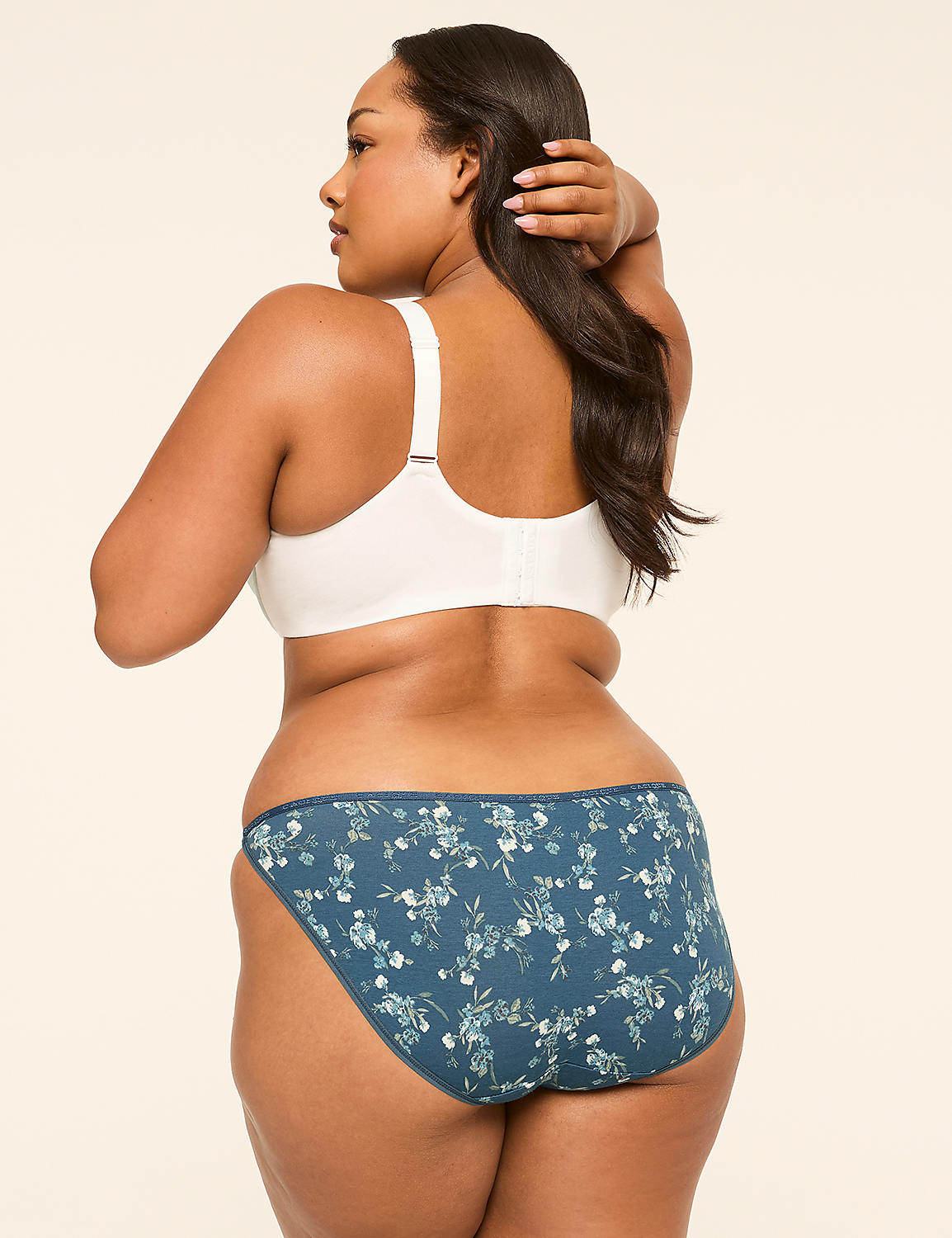 A woman in a white bra and floral underwear stands against a plain, light-colored background. Product Image 2