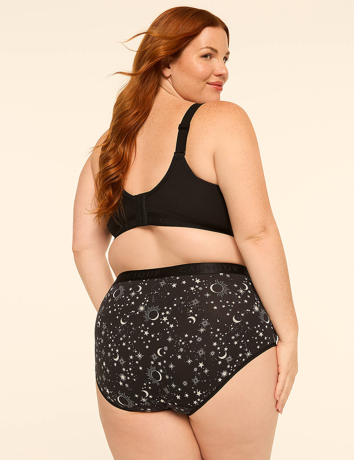 A woman with red hair, wearing a black bra and patterned underwear, stands against a plain, light-colored background. Product Image 2