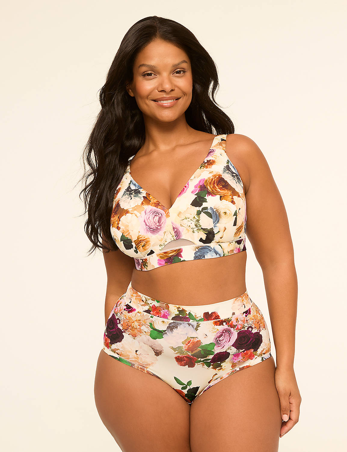A smiling woman in a floral bikini stands against a plain, light-colored background. Product Image 4