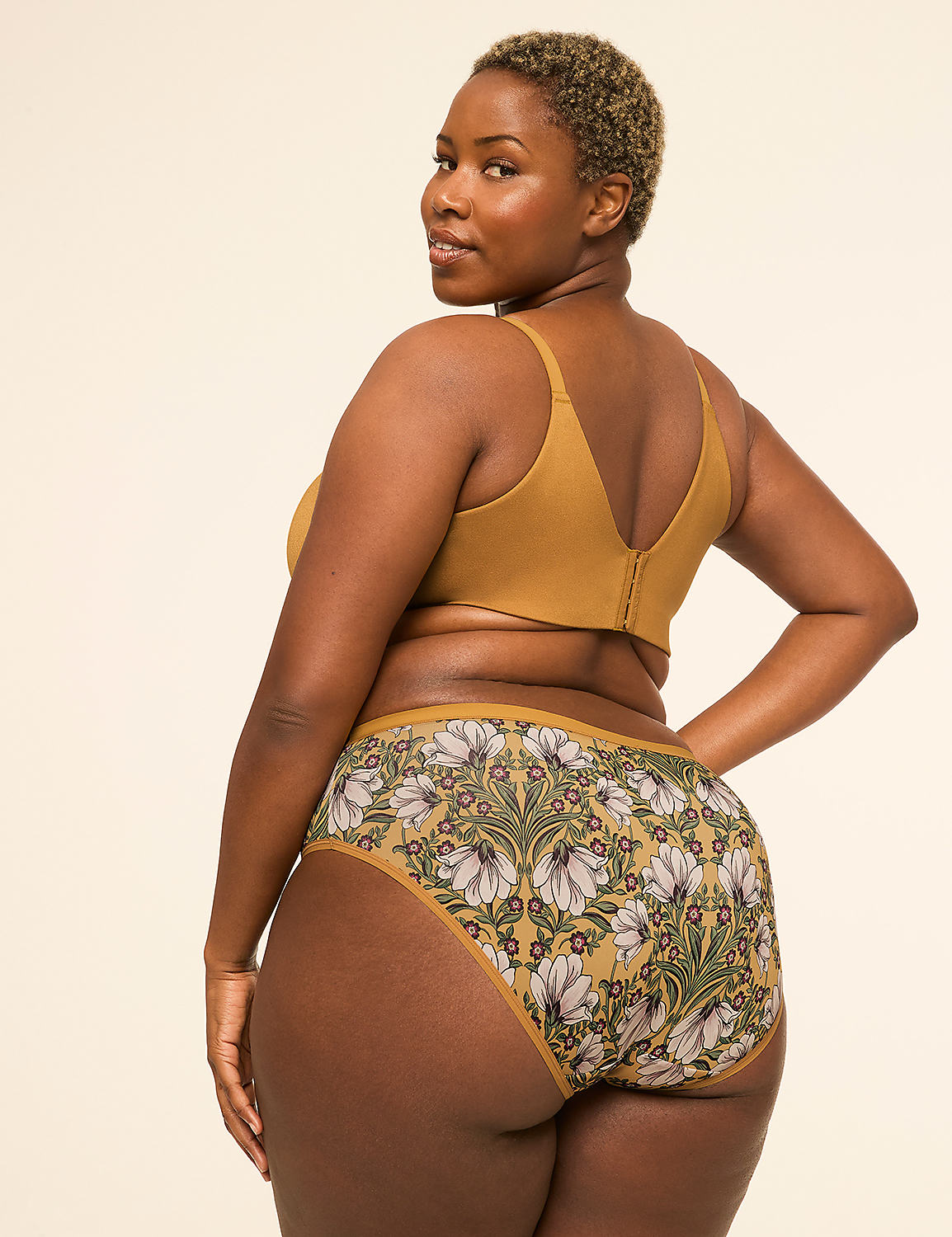 A woman in a mustard-colored bra and floral-patterned underwear poses against a plain, light-colored background. Product Image 2