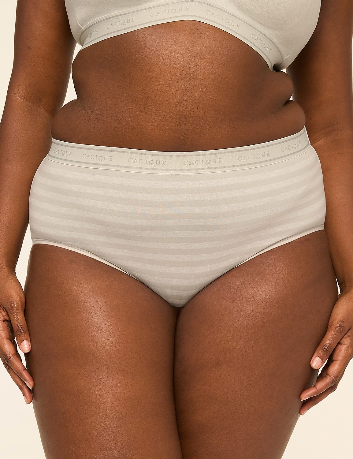 A woman's torso is shown from the waist down, wearing striped high-waisted underwear and a matching bra, against a plain background. Product Image 1