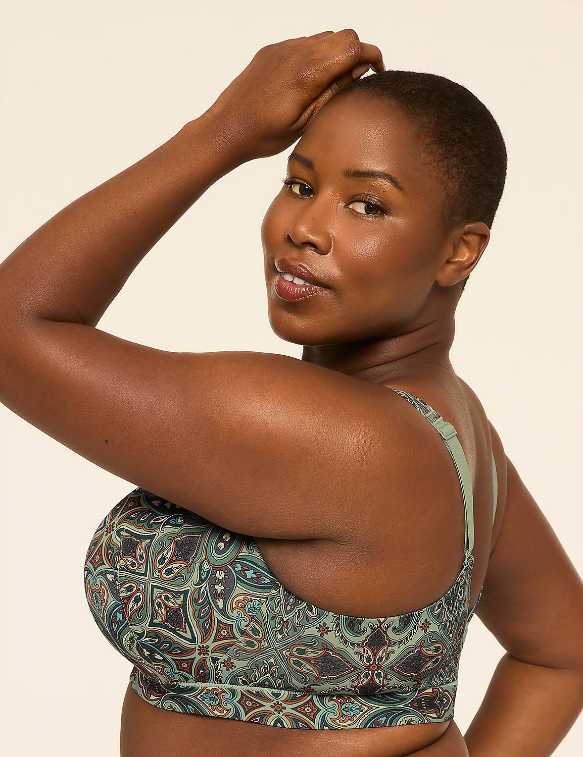 A woman with short hair and a patterned bra poses with her arm raised against a plain, light background. Product Image 3