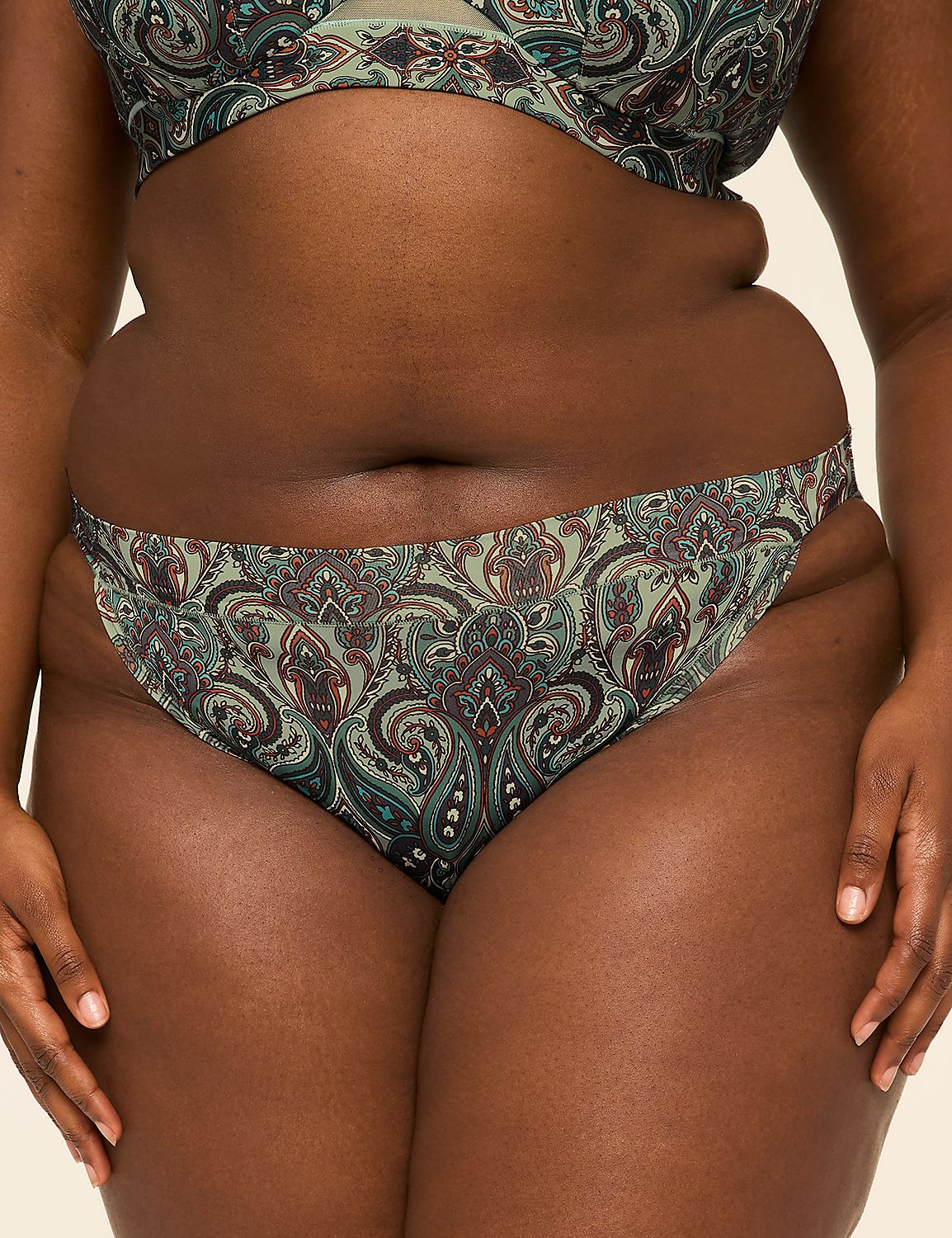 A person's midsection is shown in the foreground, wearing patterned underwear, against a plain background. Product Image 1