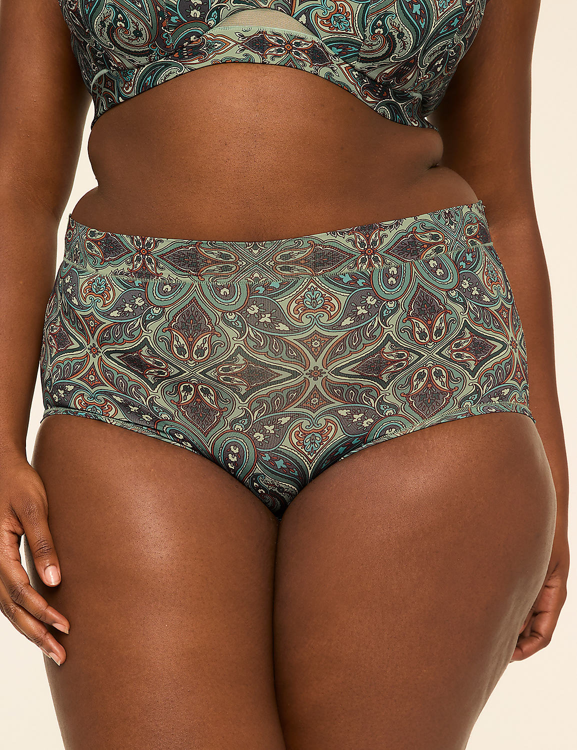 A woman's torso is shown from the waist down, wearing high-waisted patterned bikini bottoms and a matching bikini top, against a plain, light-colored background. Product Image 1