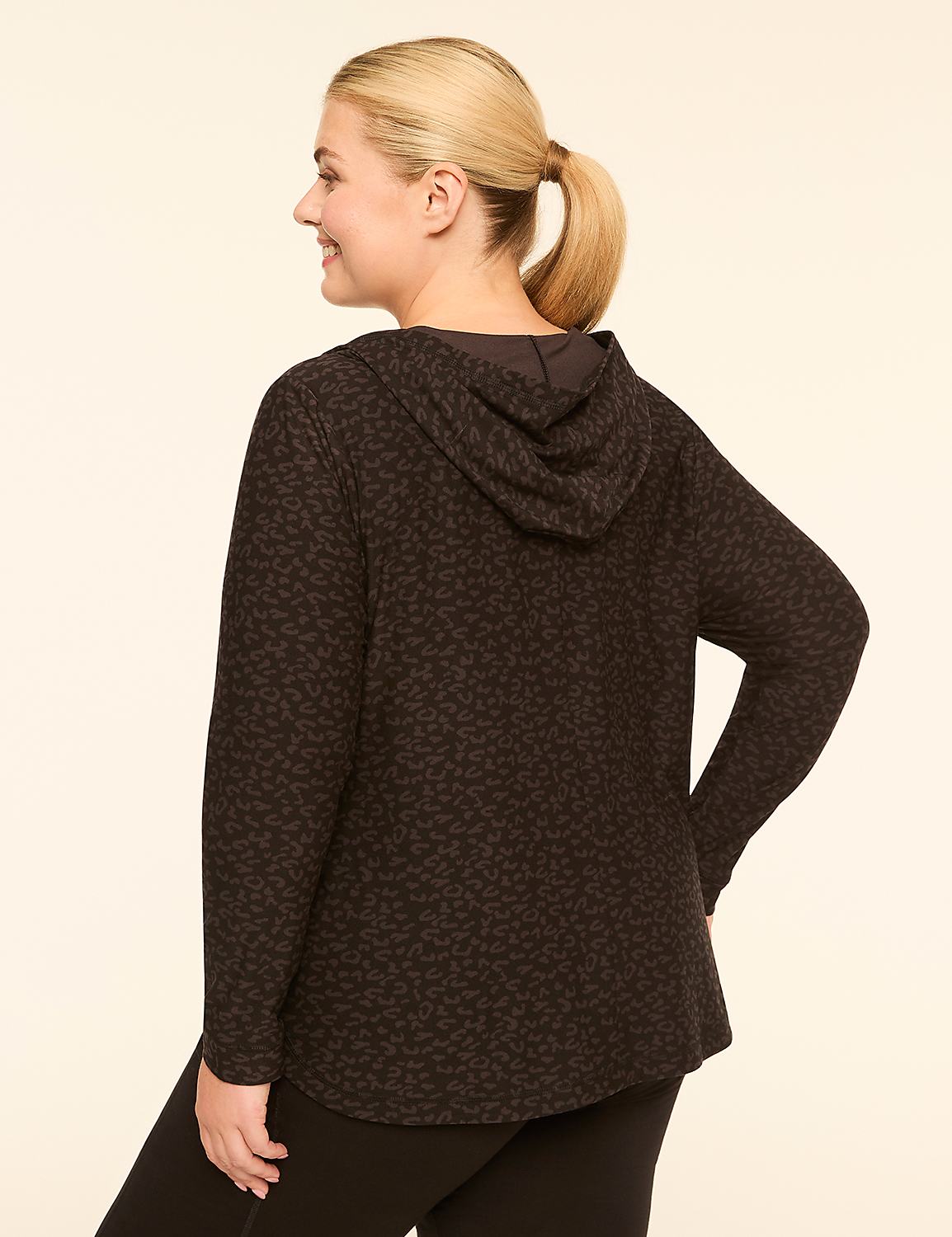 A woman in a patterned hoodie and leggings stands against a plain, light-colored background. Product Image 2