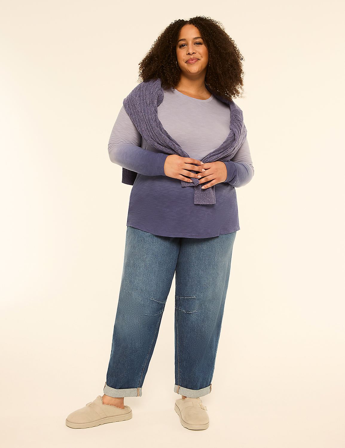 A woman in a blue sweater and jeans stands against a plain, light-colored background. Product Image 3