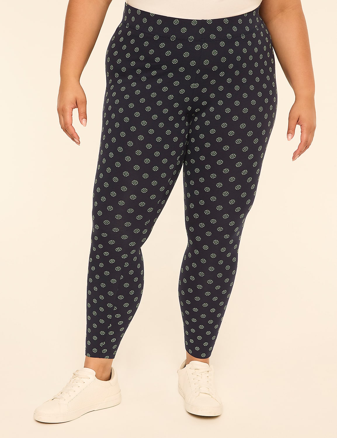 A person wearing patterned leggings and white sneakers stands against a plain, light-colored background. Product Image 1