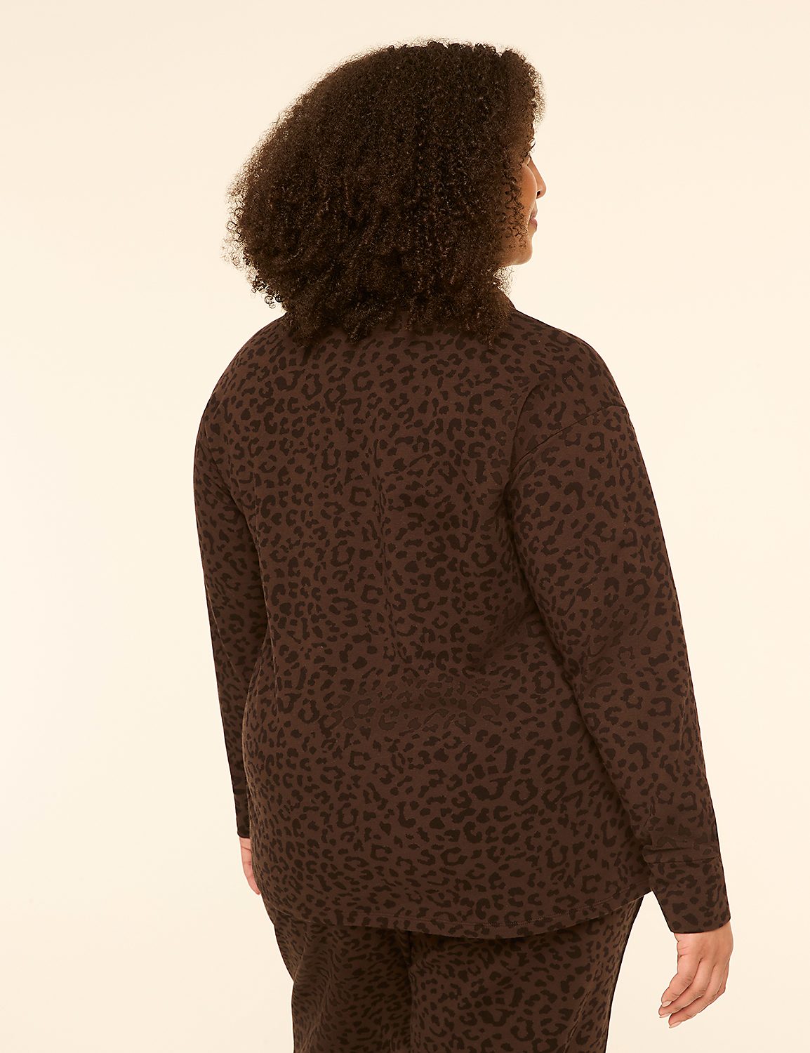 A woman with dark, curly hair stands with her back to the viewer, wearing a brown leopard-print blazer and pants against a plain, light-colored background. Product Image 2