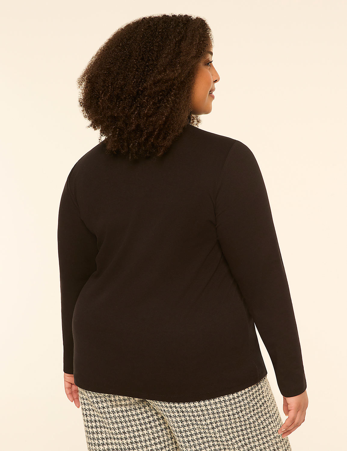 A woman with curly hair, seen from the back, wears a black long-sleeved shirt and patterned pants against a plain, light-colored background. Product Image 2
