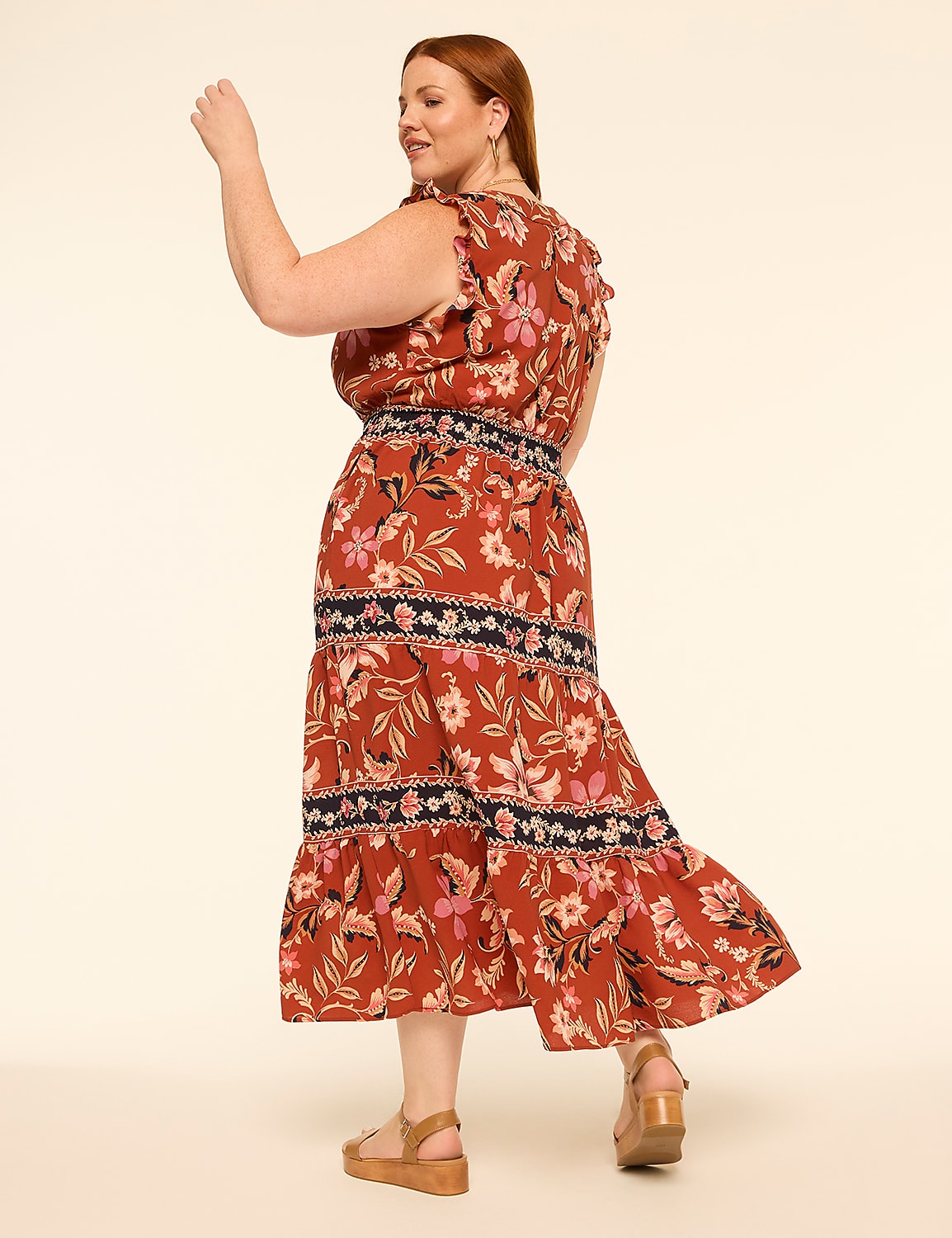 A woman in a floral print dress with ruffled sleeves and sandals stands against a plain, light-colored background. Product Image 2