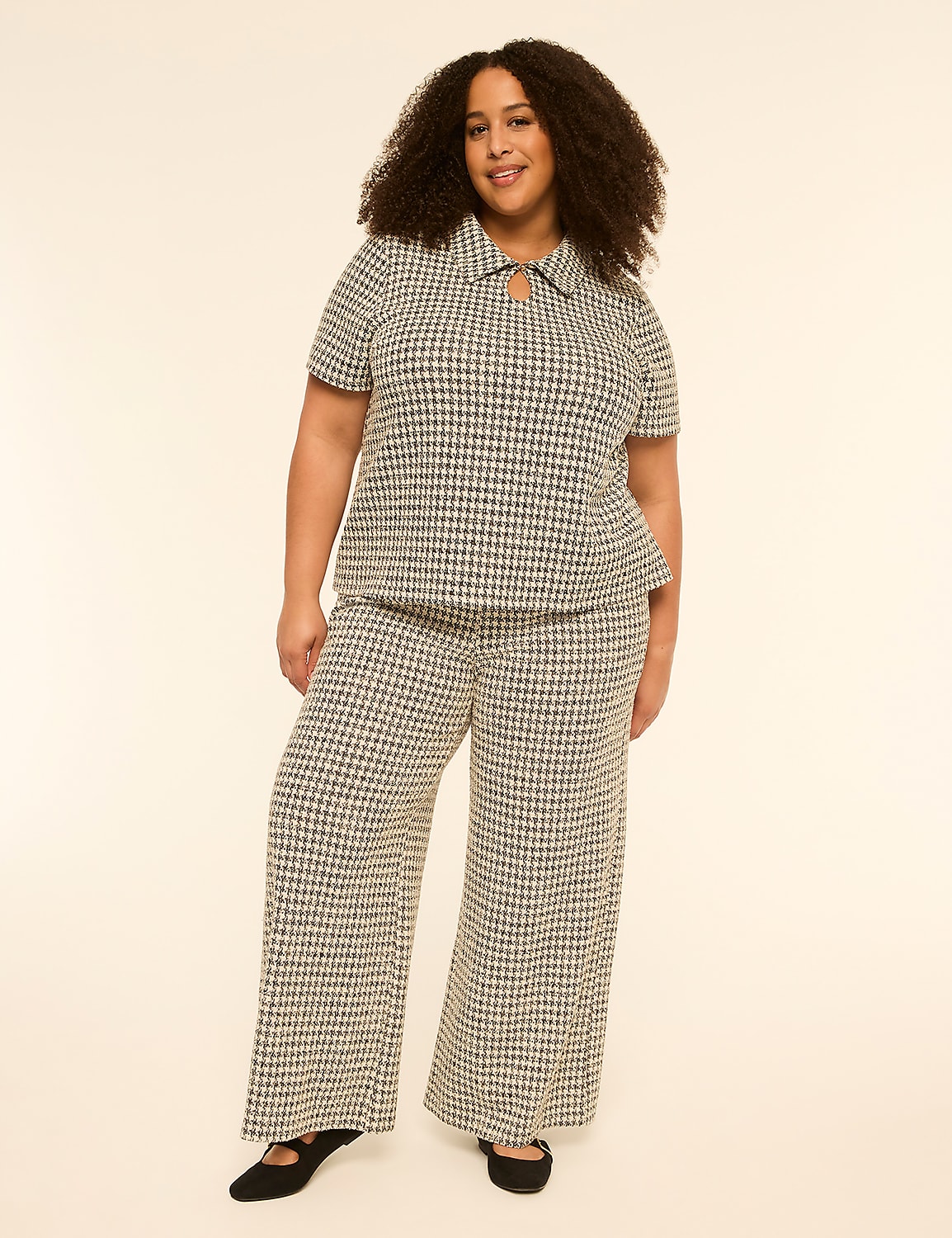 A woman in a patterned top and wide-leg pants stands against a plain, light-colored background. Product Image 3