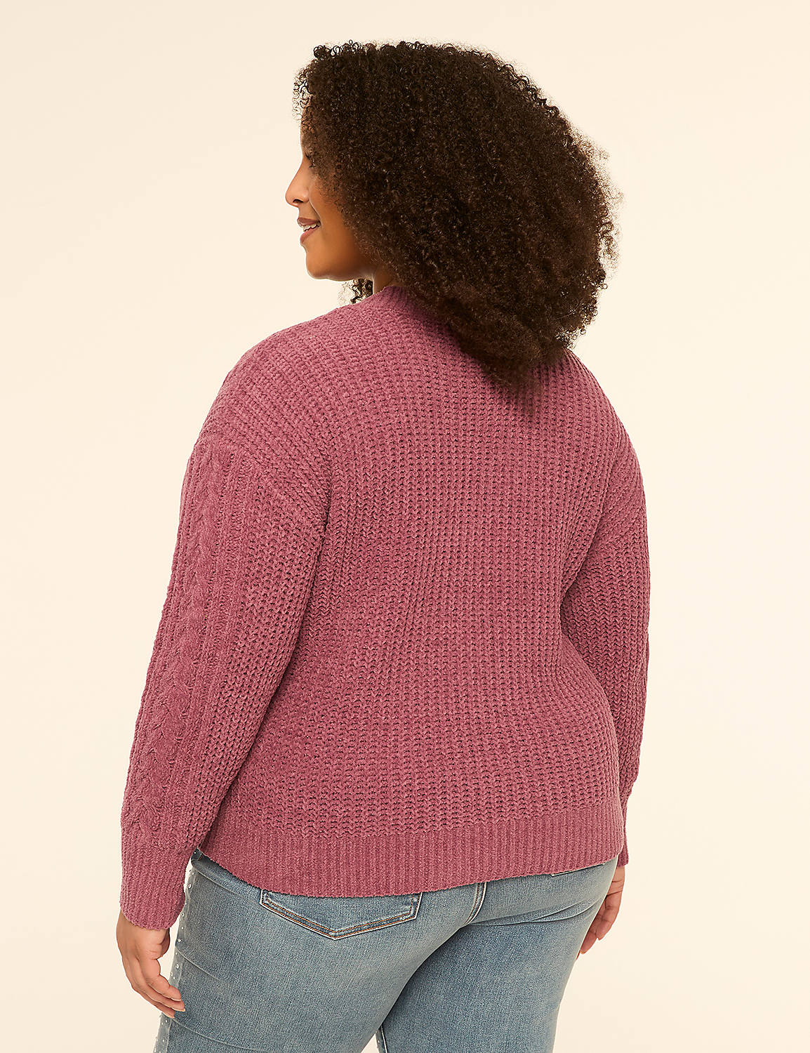 A woman in a textured pink sweater and blue jeans stands against a plain, light-colored background. Product Image 2