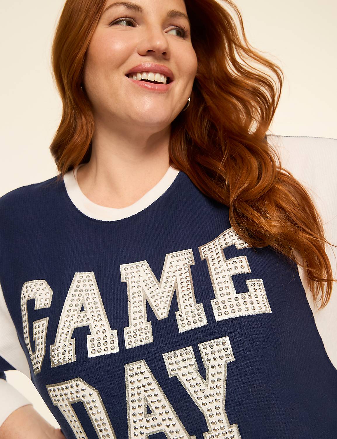 A smiling woman with red hair wears a navy blue sweater with "GAME DAY" spelled out in rhinestones, against a plain, light-colored background. Product Image 4
