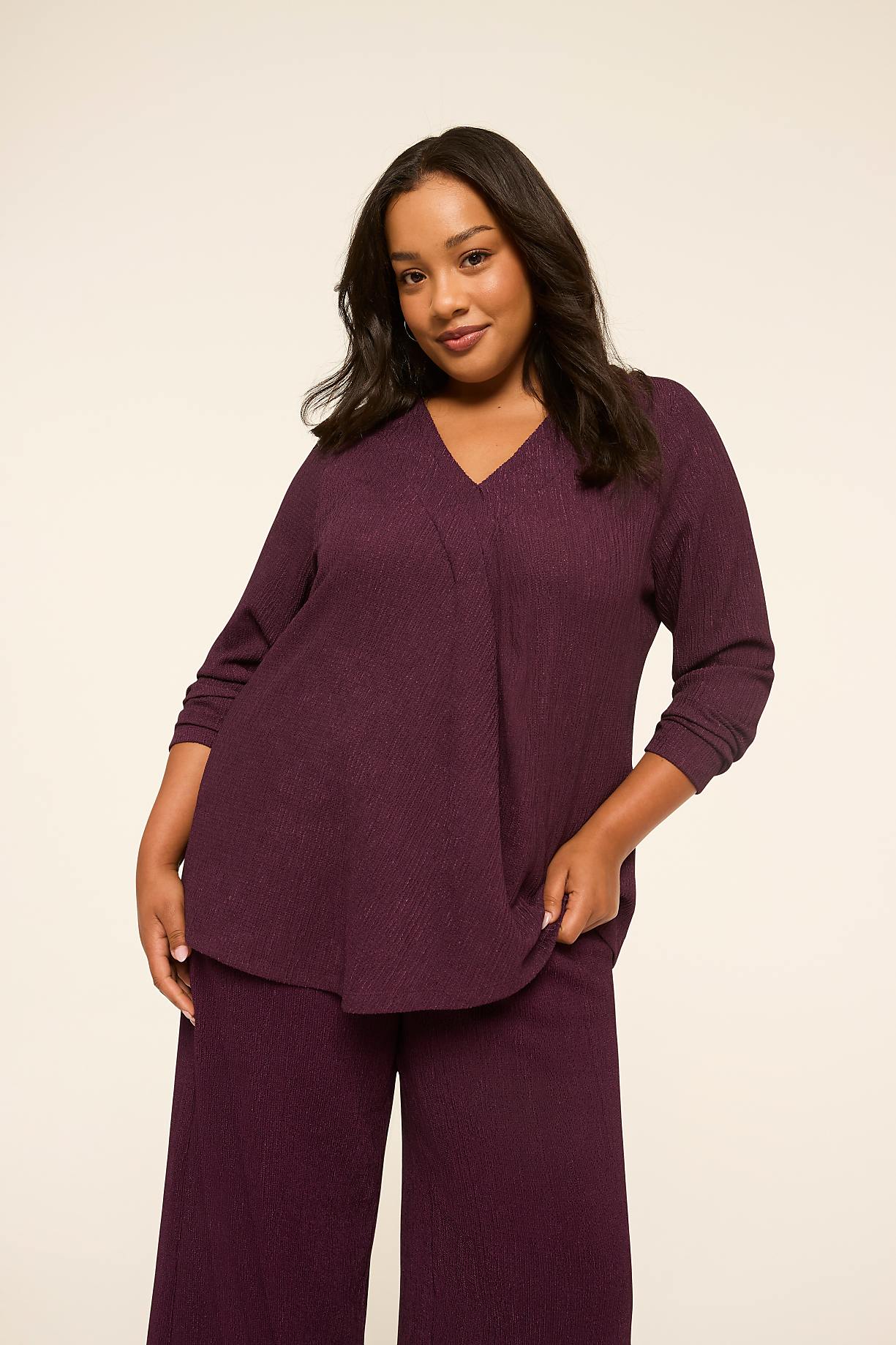 A plus-size woman in a plum-colored ribbed top and pants stands against a plain, light-colored background. Product Image 7