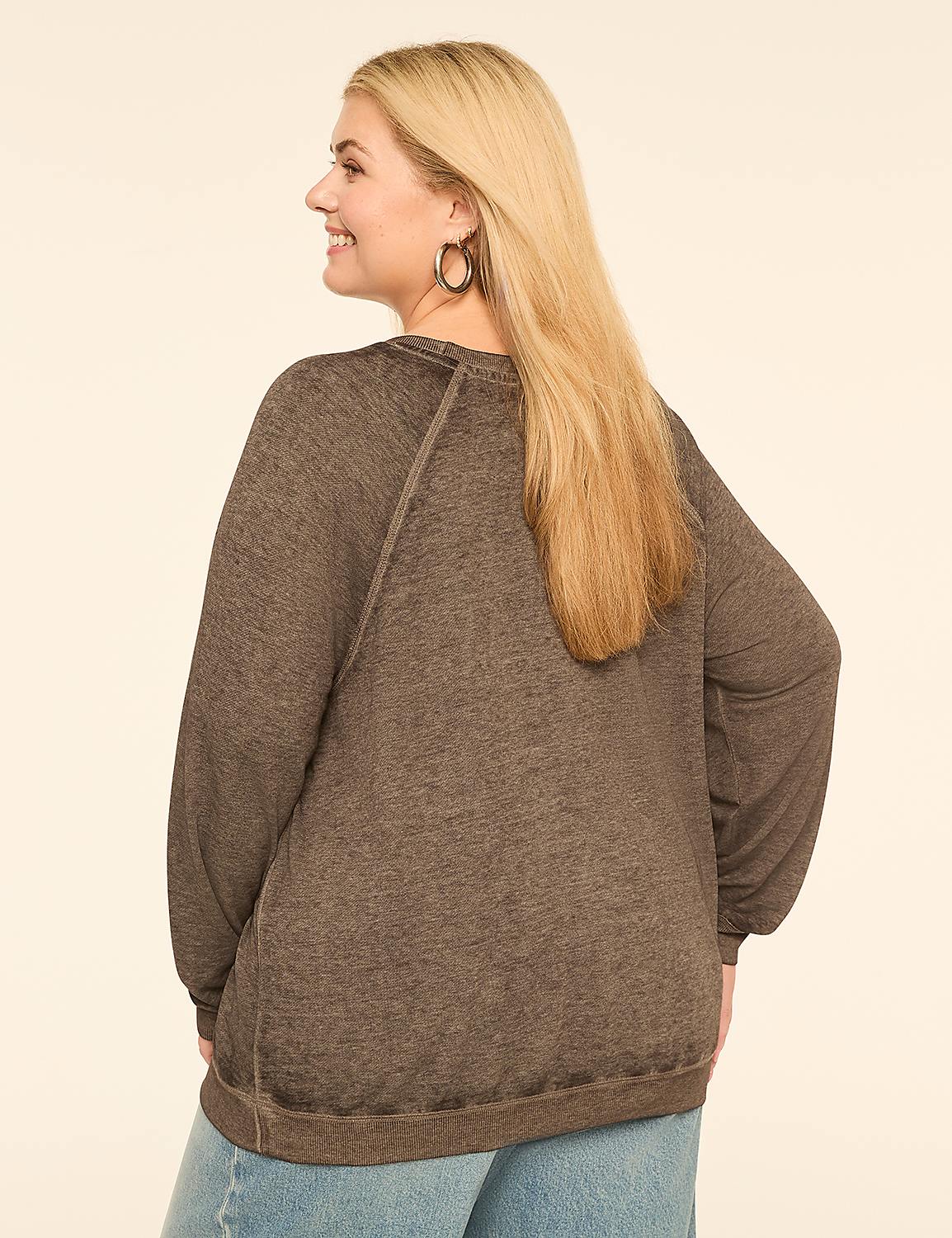 A woman with blonde hair wearing a brown sweater and blue jeans stands against a plain, light-colored background. Product Image 2