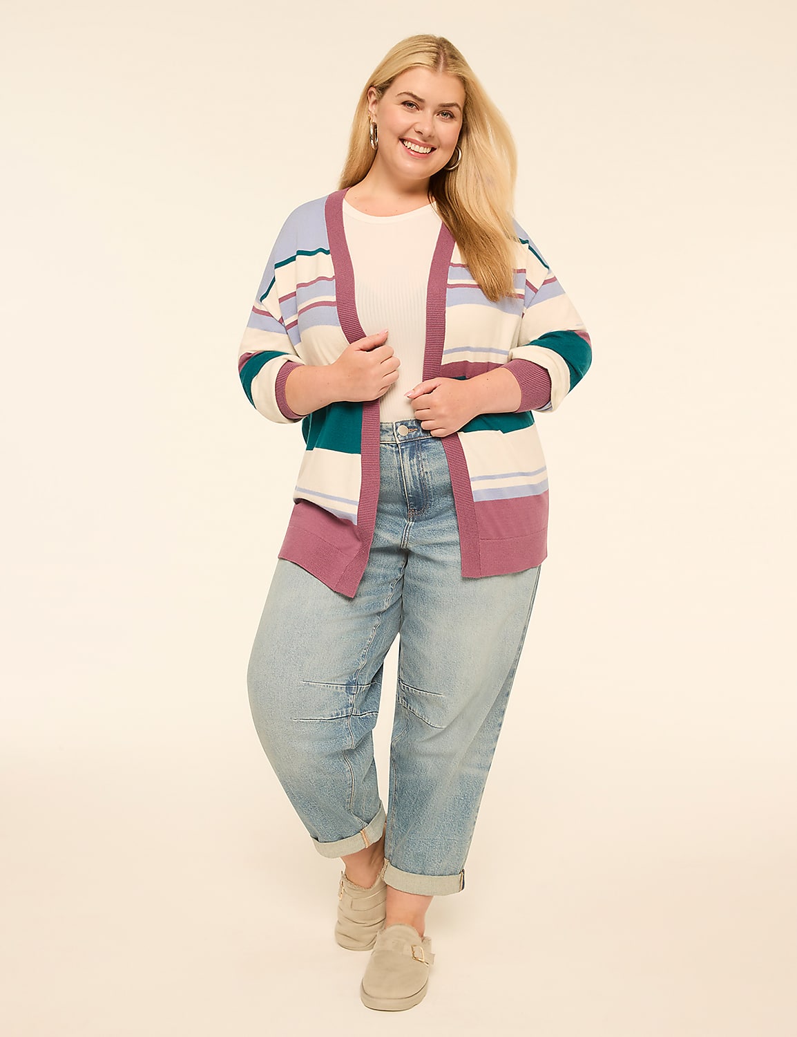A smiling woman in a striped cardigan and jeans stands against a plain, light-colored background. Product Image 3