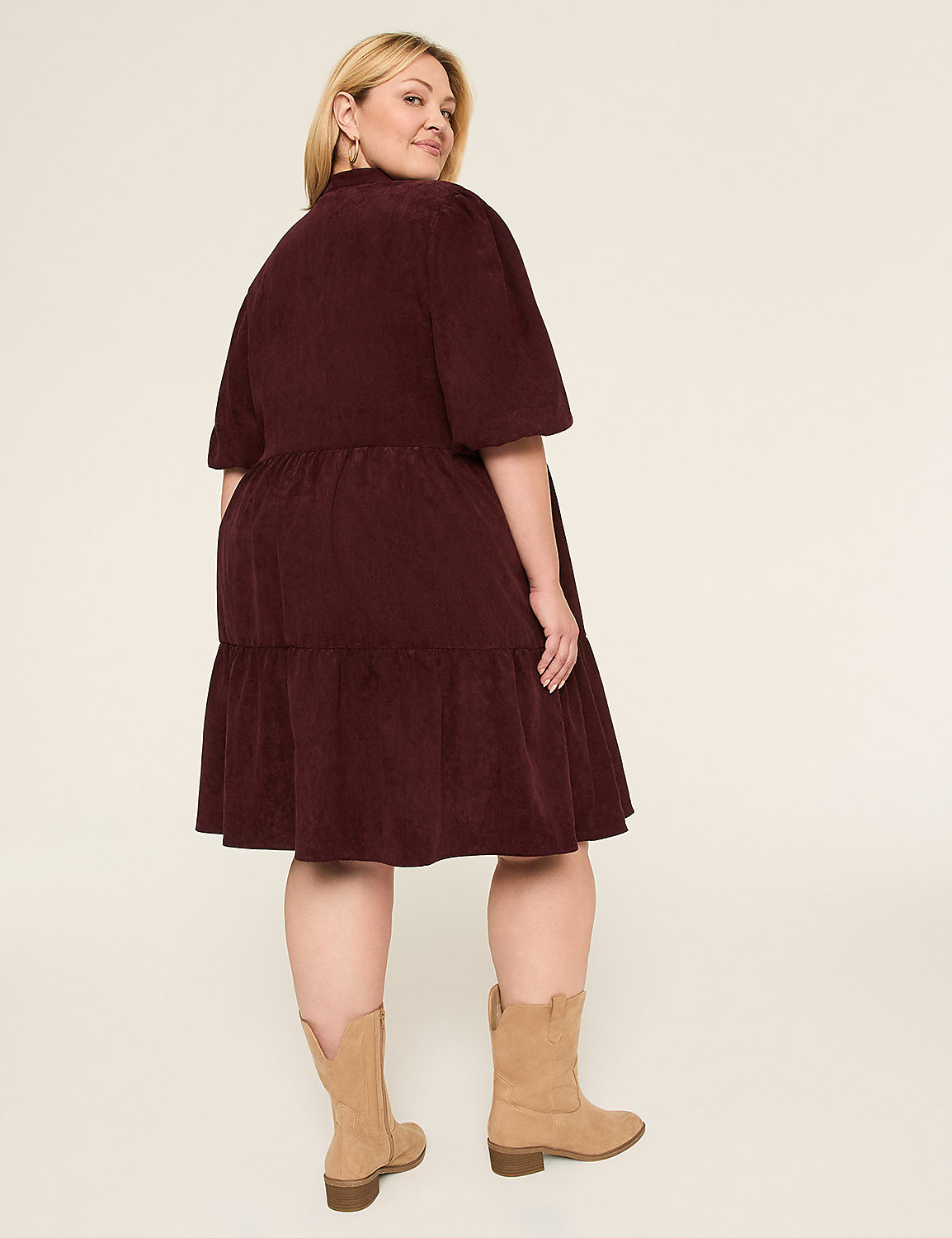 A woman in a navy blue dress stands against a plain, light-colored background. Product Image 2
