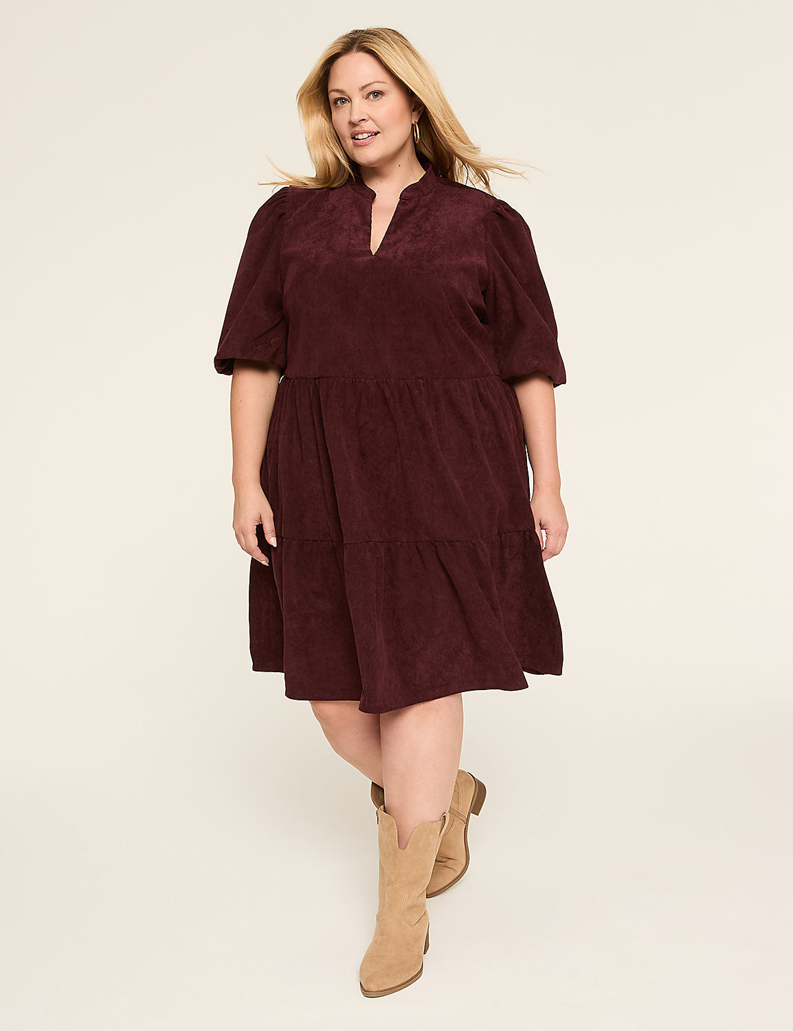 A woman in a navy corduroy dress stands against a plain, light-colored background. Product Image 1