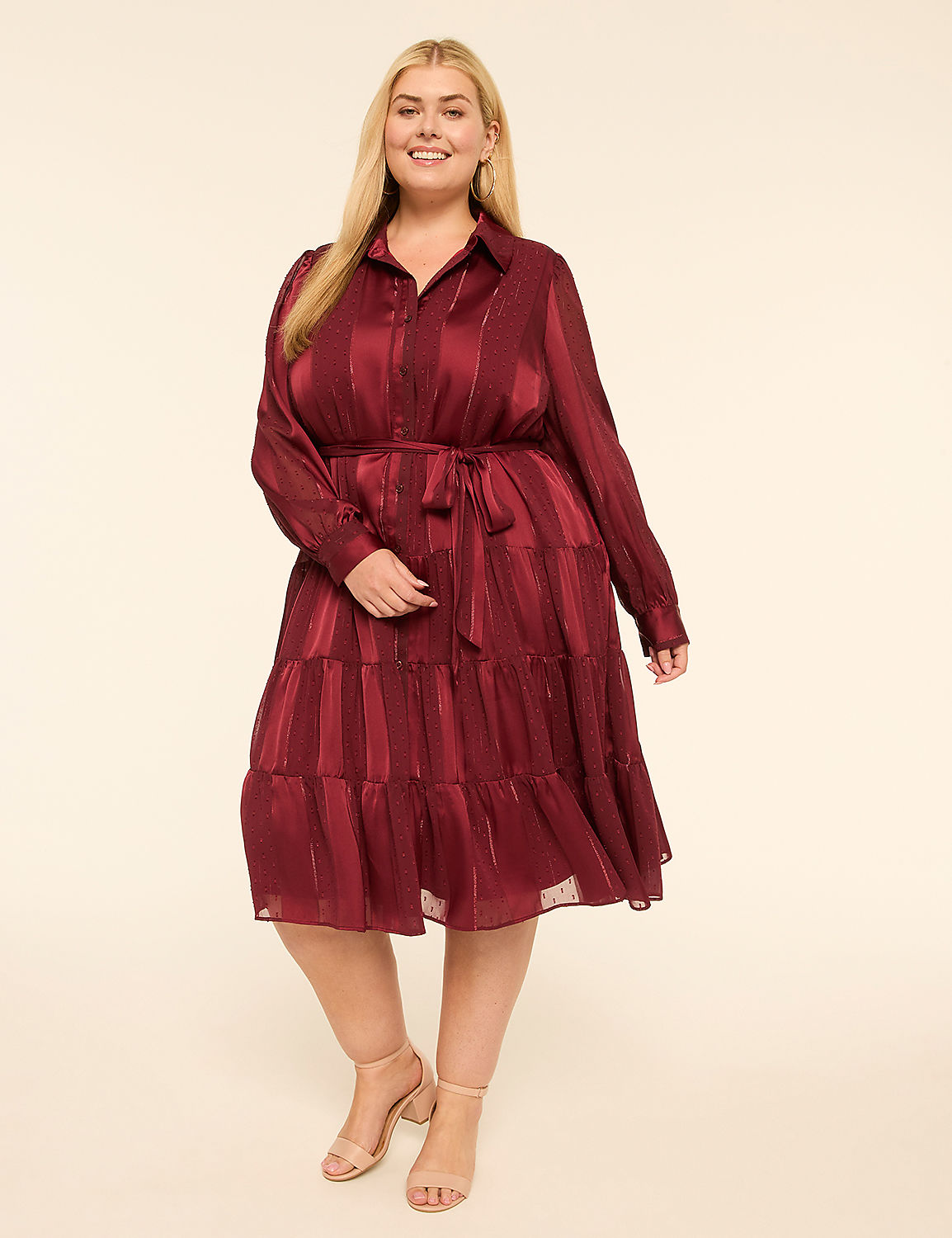 A smiling woman in a burgundy tiered dress stands against a plain cream background. Product Image 1