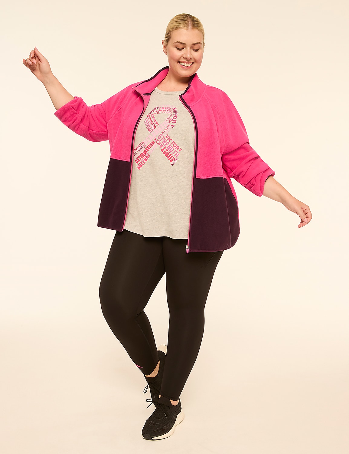 A smiling plus-size woman in a pink and purple jacket and black leggings poses against a plain, light-colored background. Product Image 3