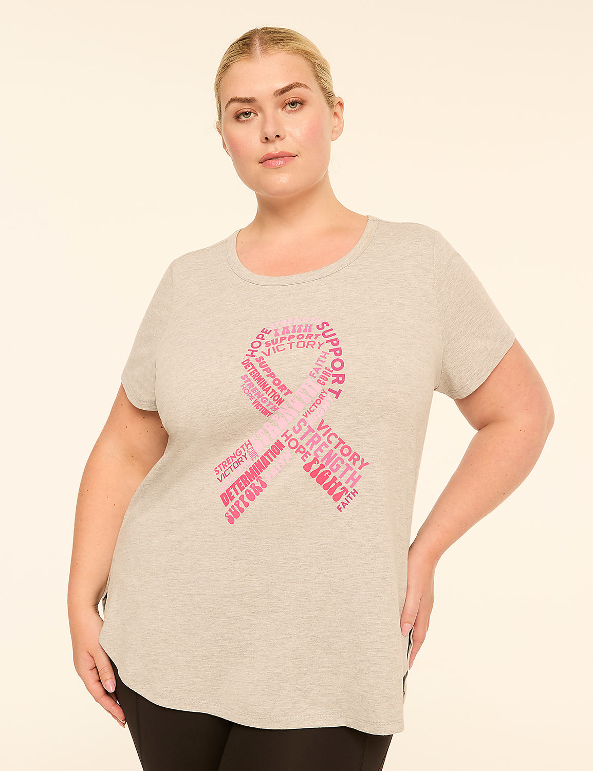 A woman in a grey t-shirt with a pink ribbon made of inspirational words stands against a plain, light background. Product Image 1